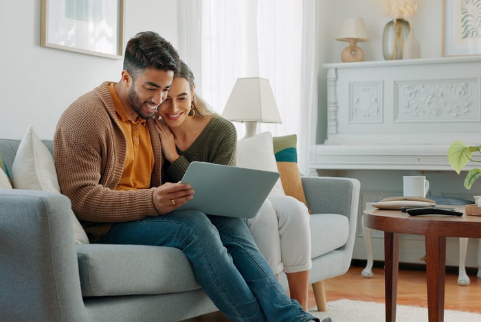 A photo of homeowners signing default management documents on their laptop A photo of homeowners signing default management documents on their laptop