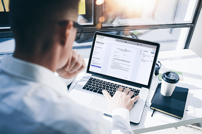 Mortgage professional with an open laptop using the Stavvy Platform for a foreclosure transaction Mortgage professional with an open laptop using the Stavvy Platform for a foreclosure transaction