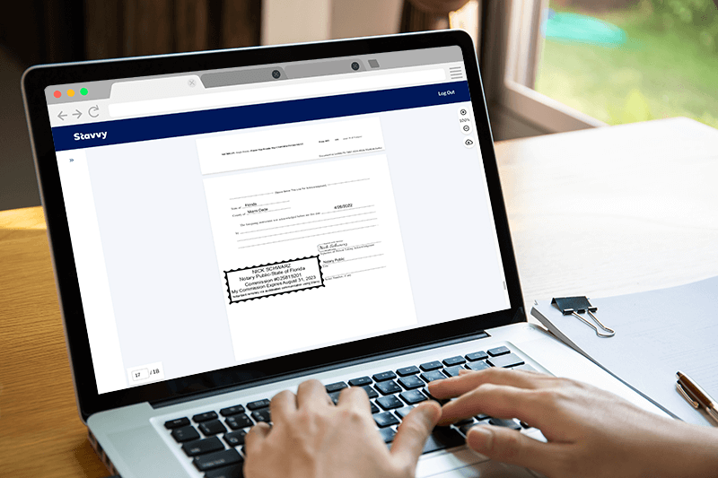 A professional notary using the Stavvy Platform to sign a mortgage document A professional notary using the Stavvy Platform to sign a mortgage document