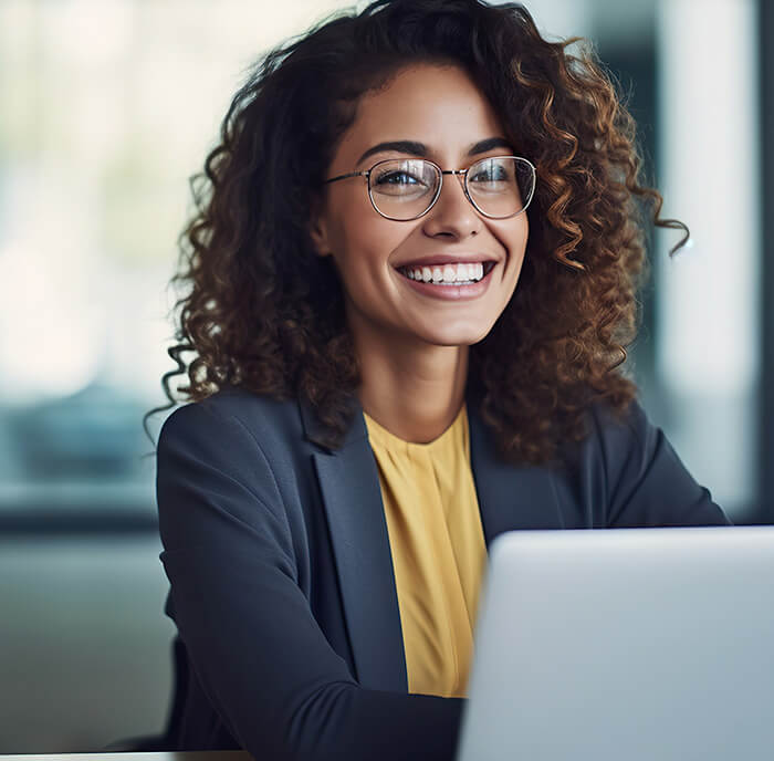 Happy real estate professional with an open laptop 